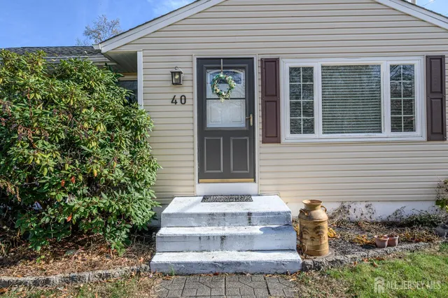 a front view of a house with plants
