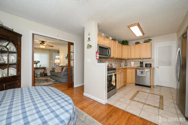 a kitchen with granite countertop a refrigerator and a stove top oven
