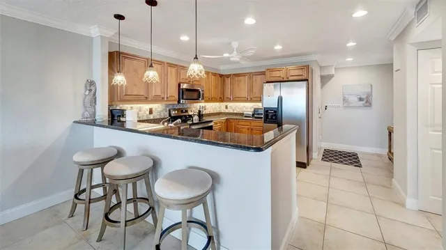 a kitchen with a dining table chairs sink and cabinets
