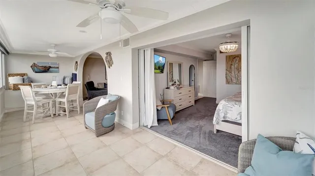 a living room with furniture a table and chairs