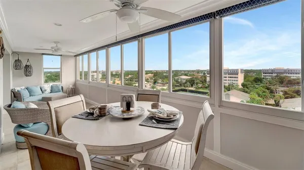 a dining room with furniture a chandelier and fireplace
