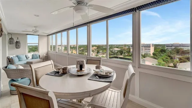 a dining room with furniture a chandelier and fireplace