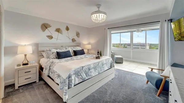 a bedroom with a bed and a chandelier