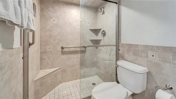 a white toilet sitting next to a bathroom sink