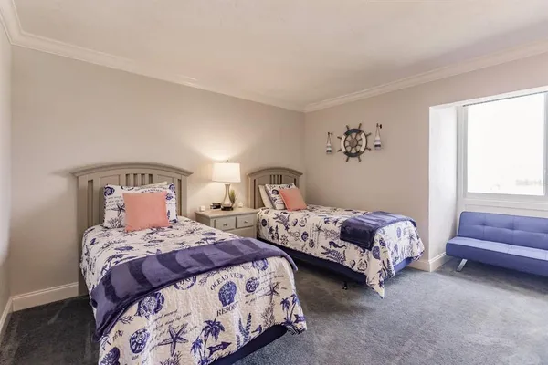 a bedroom with two beds and a window