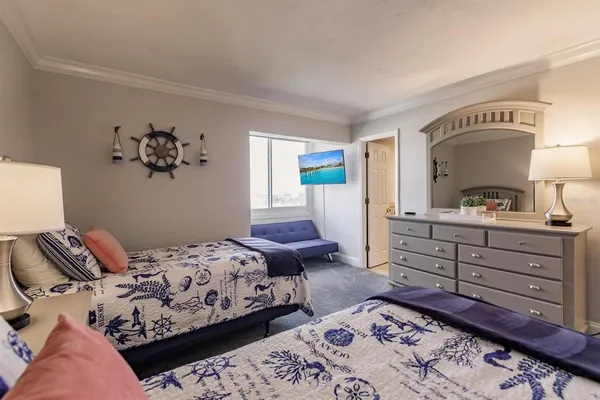 a bedroom with a bed and a dresser in it