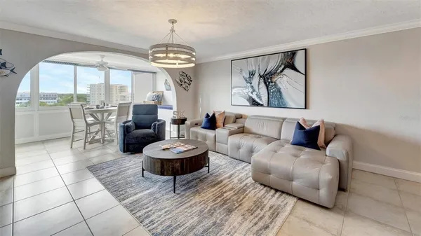 a living room with furniture a fireplace and a table