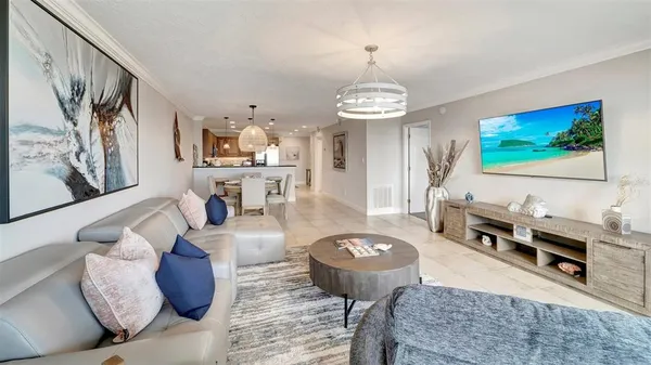 a living room with furniture and a chandelier