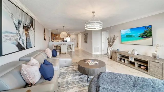 a living room with furniture and a chandelier