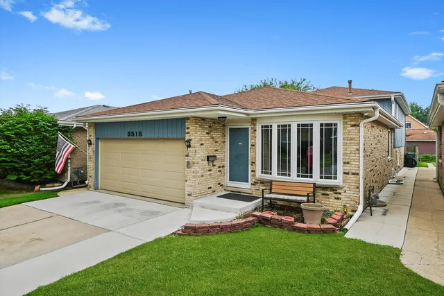a front view of a house with a garden and yard