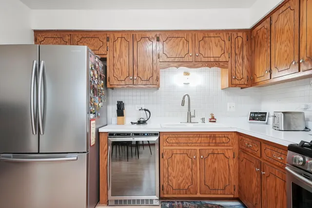 a kitchen with stainless steel appliances granite countertop a refrigerator and a sink