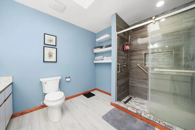 a bathroom with a toilet and shower