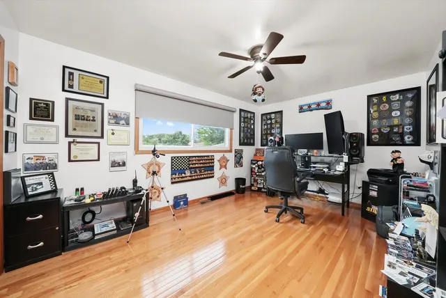 a view of a workspace with furniture and a window