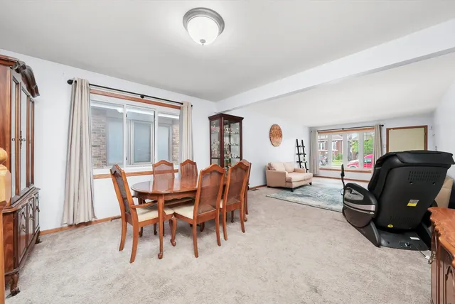 a view of a dining room with furniture and a window