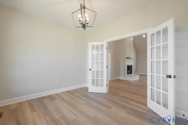 wooden floor in an empty room with a window