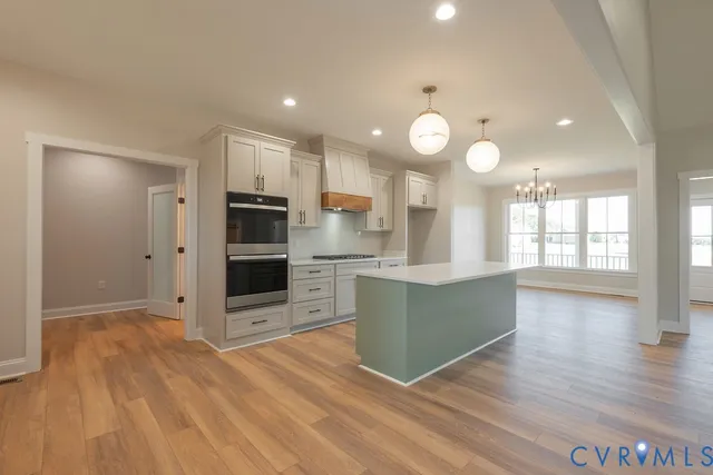 a view of a kitchen with wooden floor and a window
