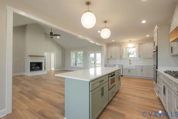 a kitchen with stainless steel appliances granite countertop a stove a sink and a refrigerator