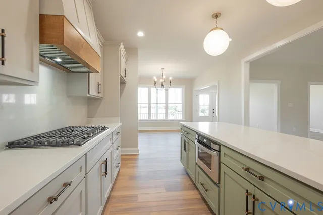 a kitchen with stainless steel appliances granite countertop a stove and a sink