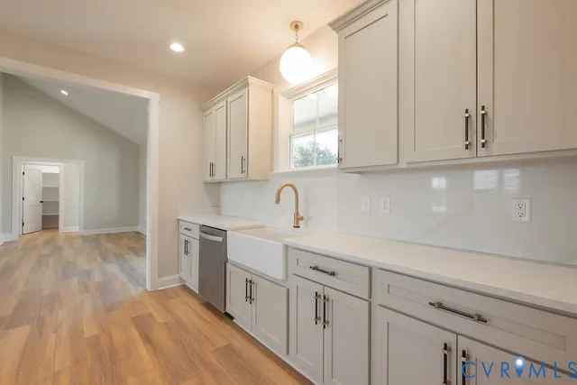 a kitchen with granite countertop a stove and cabinets