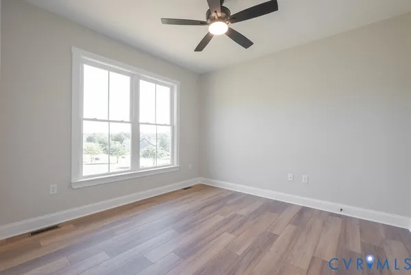 a view of an empty room and wooden floor