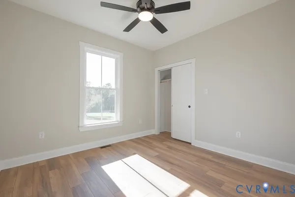 wooden floor in an empty room with a window