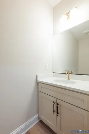 an empty room with wooden floor closet and windows