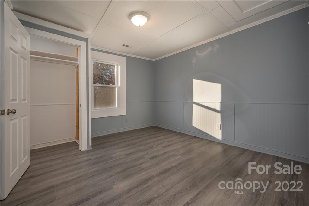 147 North Ridgecrest Avenue Rutherfordton, NC 28139 - Photo 11 of 21 an empty room with wooden floor and windows
