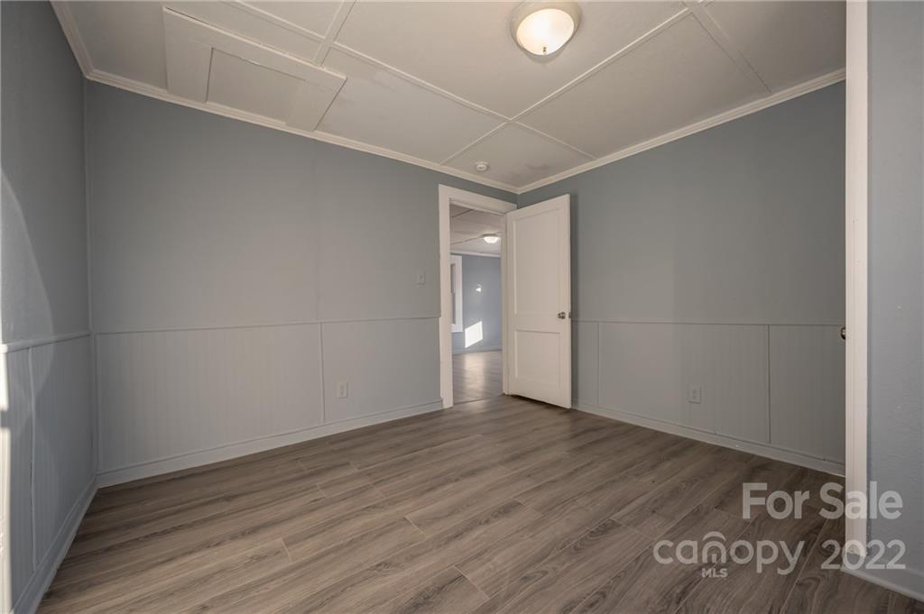 147 North Ridgecrest Avenue Rutherfordton, NC 28139 - Photo 12 of 21 a view of an empty room with wooden floor