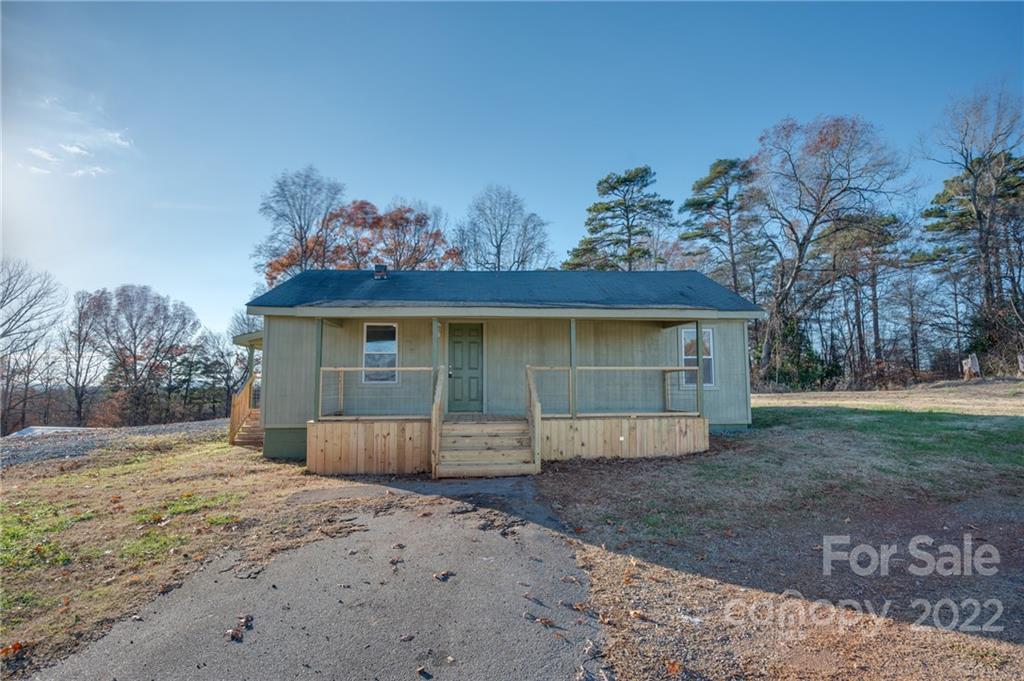 147 North Ridgecrest Avenue Rutherfordton, NC 28139 - Photo 20 of 21 a front view of a house with a yard and garage
