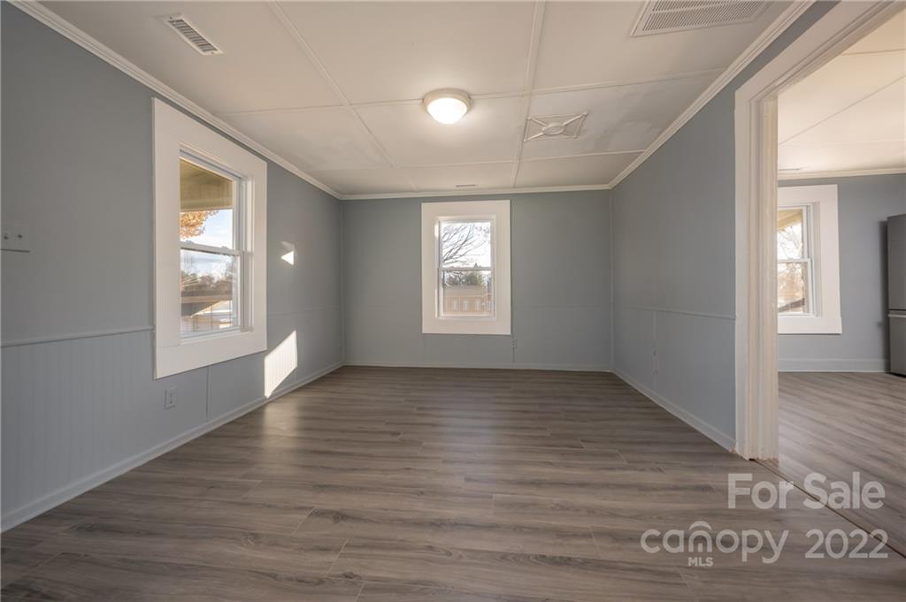 147 North Ridgecrest Avenue Rutherfordton, NC 28139 - Photo 3 of 21 a view of an empty room with window and wooden floor