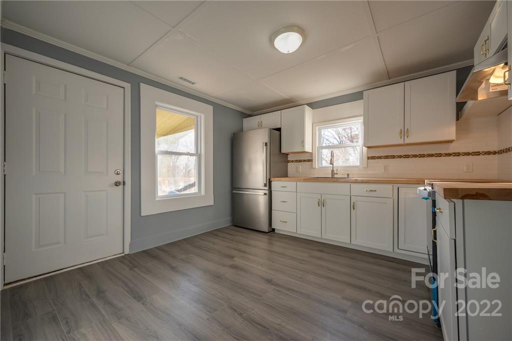 147 North Ridgecrest Avenue Rutherfordton, NC 28139 - Photo 5 of 21 a kitchen with granite countertop a sink cabinets stainless steel appliances and a window