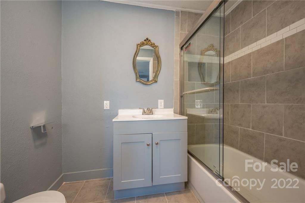 147 North Ridgecrest Avenue Rutherfordton, NC 28139 - Photo 10 of 21 a bathroom with a sink mirror and toilet