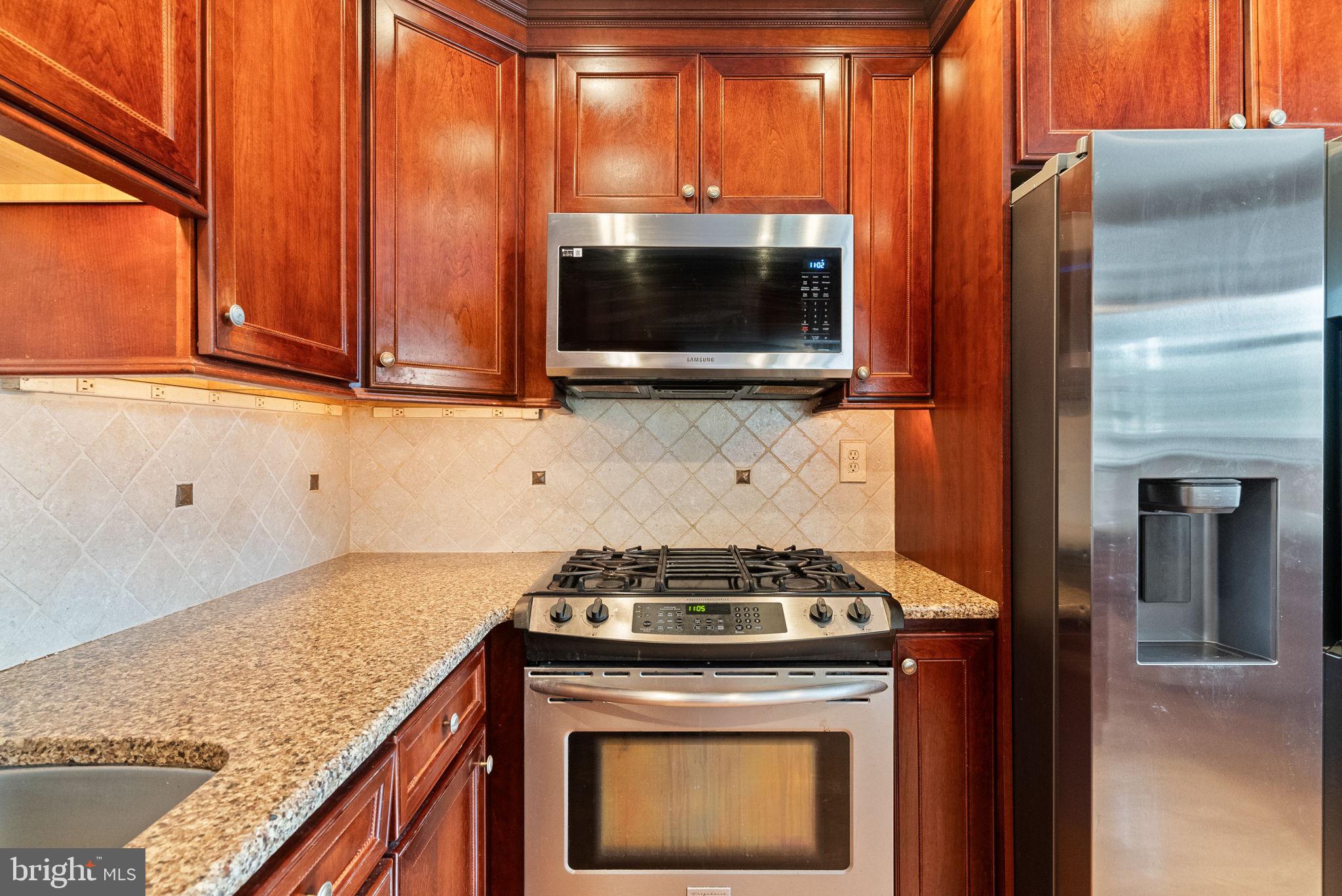 3201 Fairway Road Bensalem, PA 19020 - Photo 31 of 54 a kitchen with a stove and a microwave