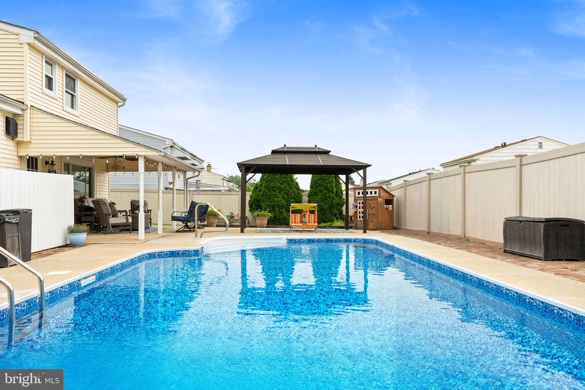 3201 Fairway Road Bensalem, PA 19020 - Photo 4 of 54 a view of a patio with swimming pool table and chairs