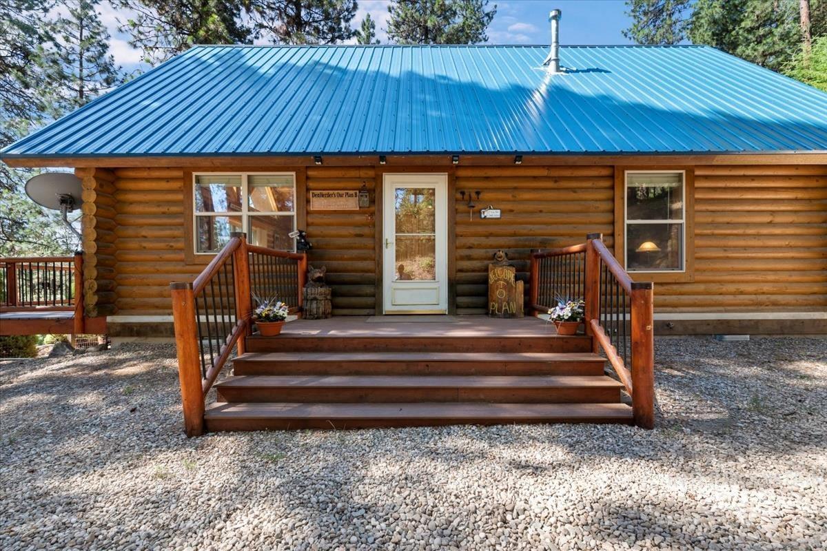 10 Elk Point Road Garden Valley, ID 83622 - Photo 39 of 42 Entrance to property with log exterior, a wooden deck, and a metal roof