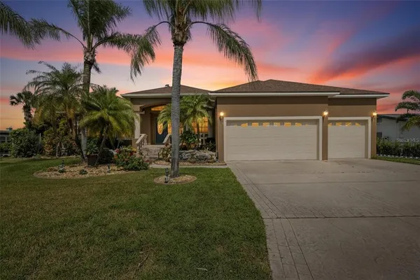 a front view of house with yard and green space