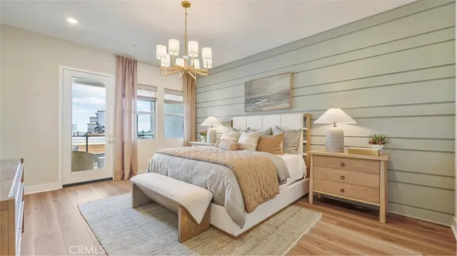 a spacious bedroom with a bed and a chandelier