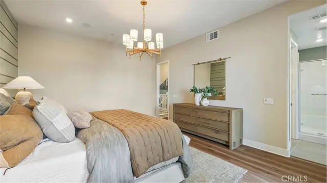 a bedroom with a bed and a chandelier