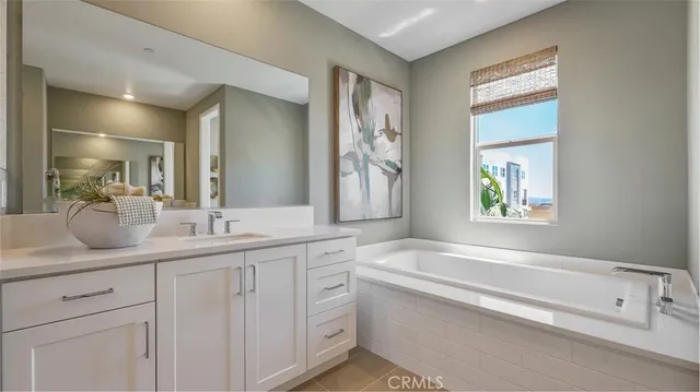 a bathroom with a granite countertop sink mirror and bathtub