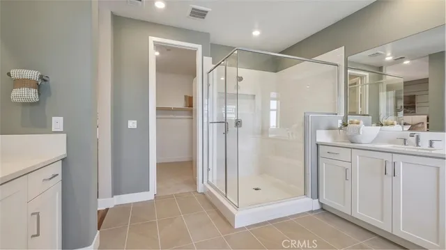 a bathroom with a shower sink and mirror