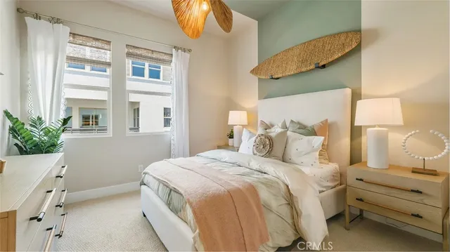 a bedroom with a bed and a potted plant