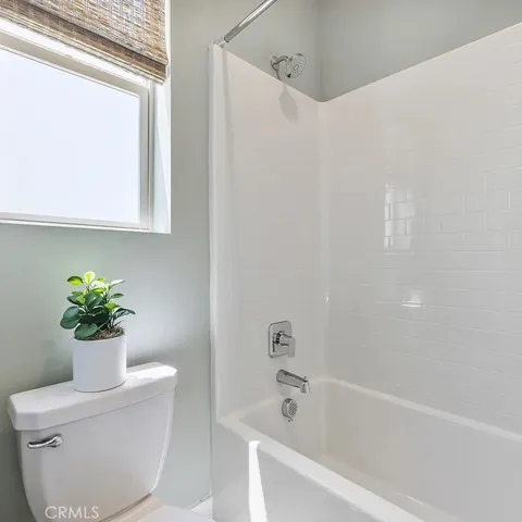 a bath room with a toilet and a bath tub