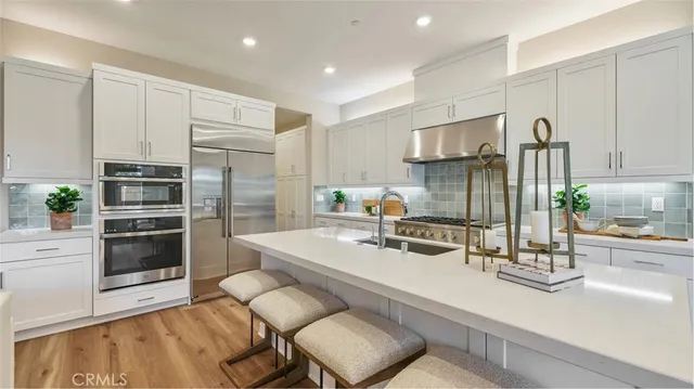 a kitchen with stainless steel appliances a sink and a refrigerator