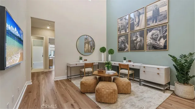 a living room with furniture a window and a clock