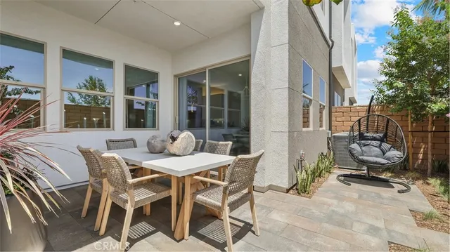 a view of a patio with table and chairs and potted plants