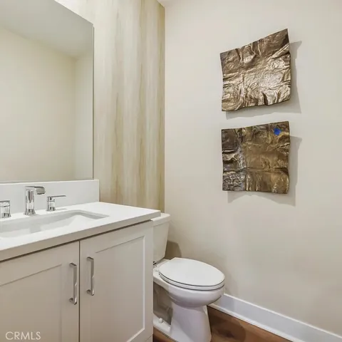 a bathroom with a sink mirror and toilet