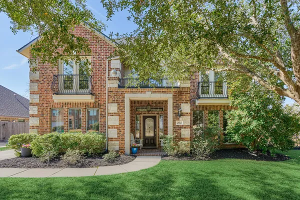 a front view of a house with a garden and plants