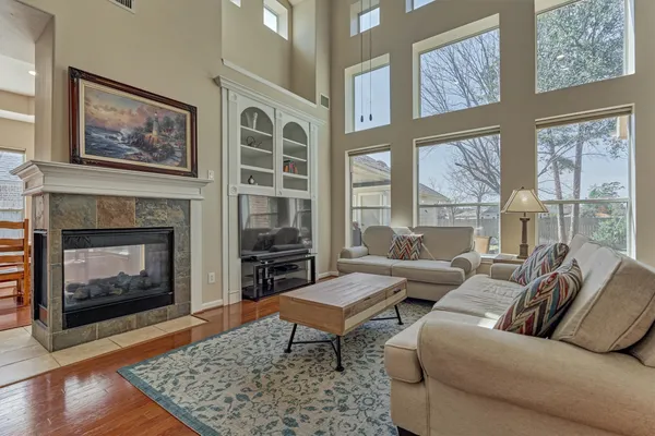 a living room with furniture windows and a fireplace