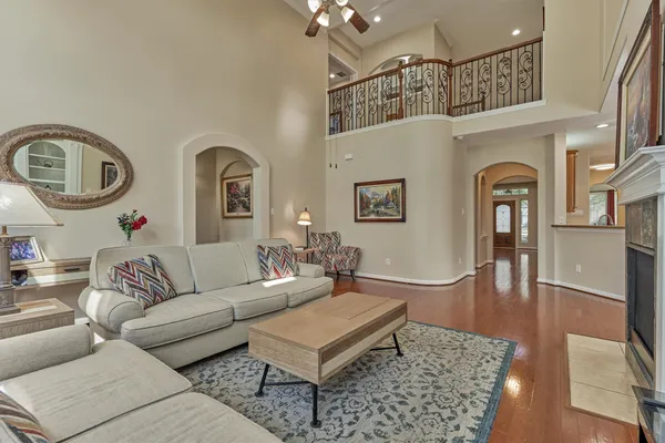 a living room with furniture a rug and a chandelier