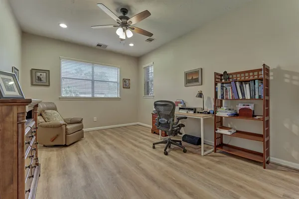 a view of a workspace with furniture and a window